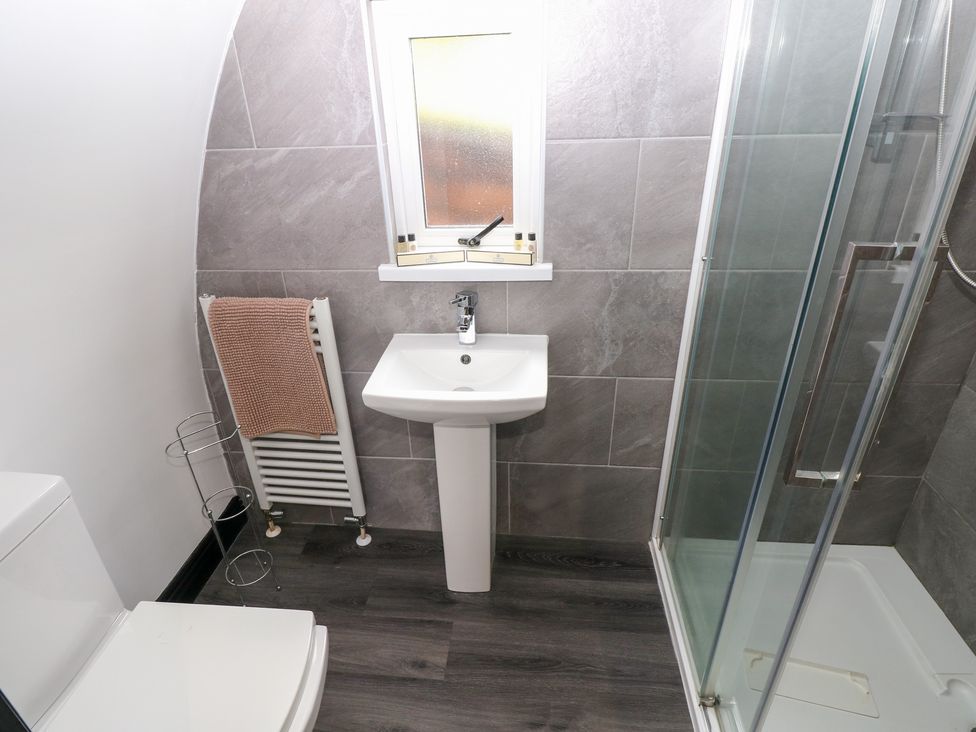 A bathroom with a shower and sink at Cwtch Bach in Aberdare