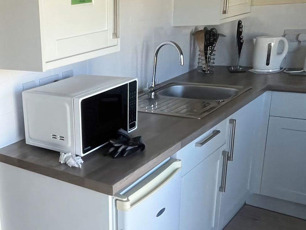 A kitchen with a microwave and sink at Stanbury