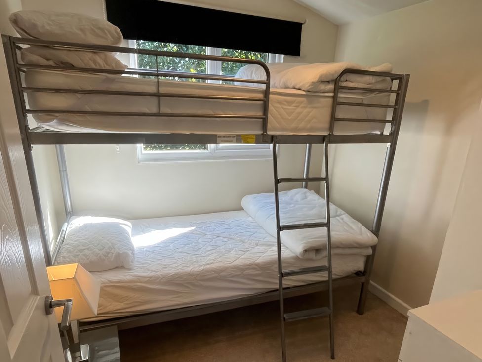 A bedroom with a bunk bed and a lamp at Stanbury
