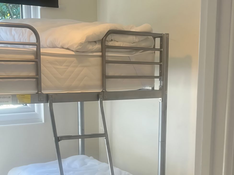 A bunk bed in a room with a window at Stanbury