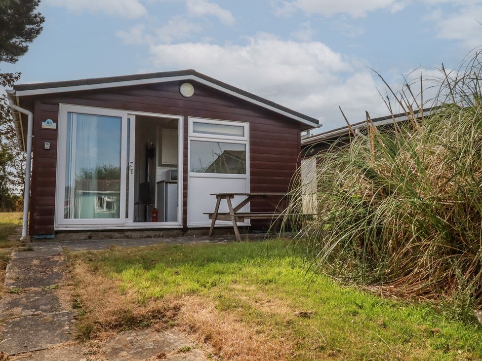 A cabin with a table and grass at Stanbury in St Merryn