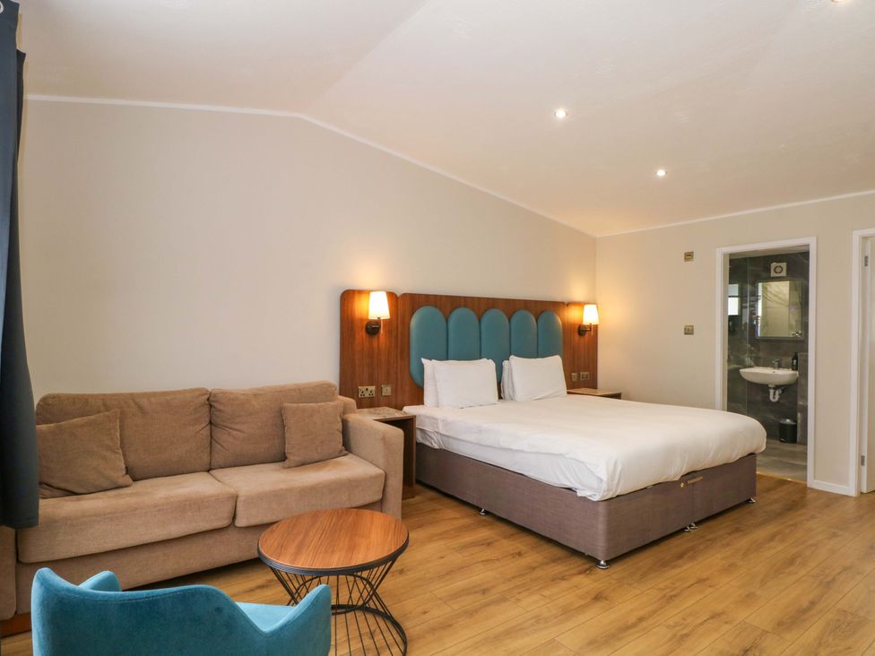 A bedroom with a bed and sofa at 1 bed no. 1