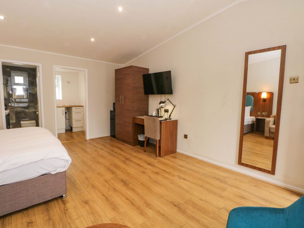 A bedroom with a bed and desk at 1 bed no. 1