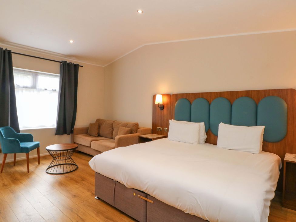 A bedroom with a bed and sofa at 1 bed no. 1 