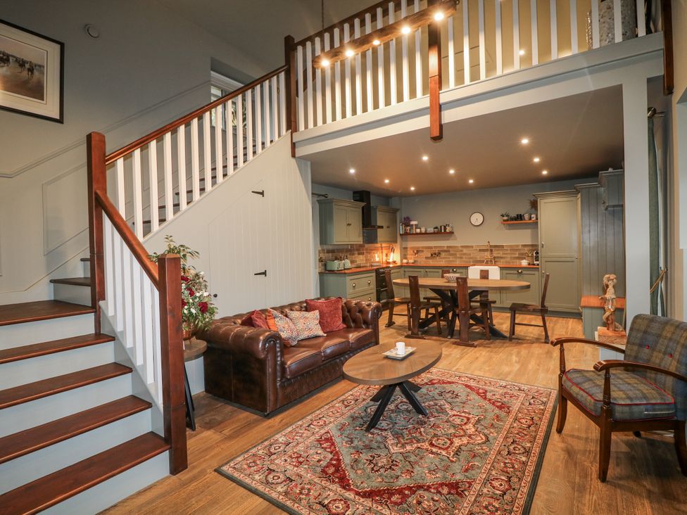 A living room with a sofa and dining area at Robins Rest at The Lodge in Kilmacthomas