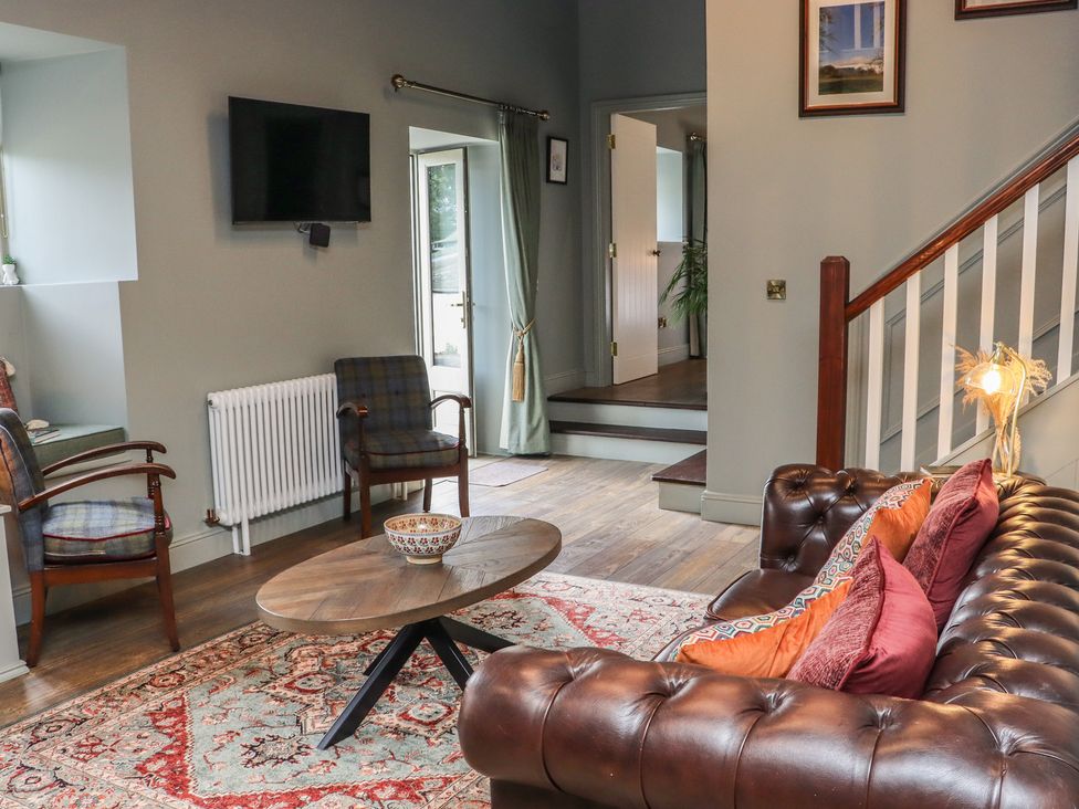 A living room with a sofa and coffee table at Robins Rest at The Lodge, Ahanaglogh near Kilmacthomas, County Waterford