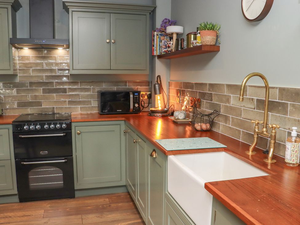 A kitchen with cabinets, sink, oven, and microwave at Robins Rest at The Lodge Ahanaglogh near Kilmacthomas, County Waterford