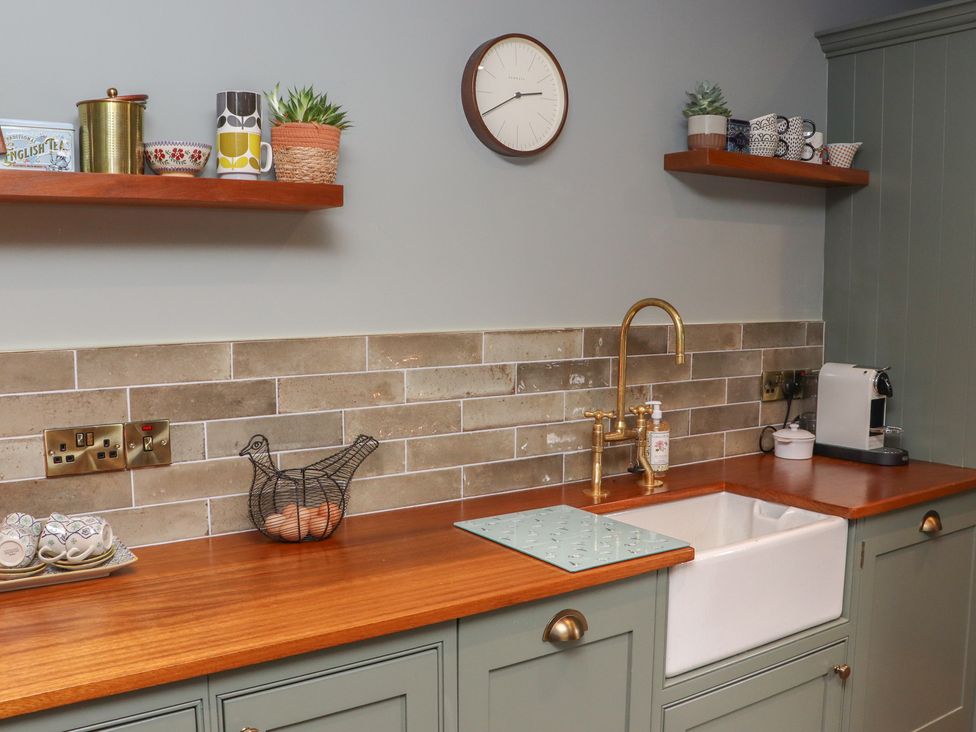 A kitchen with a sink, faucet, and various utensils at Robins Rest at The Lodge Ahanaglogh near Kilmacthomas, County Waterford