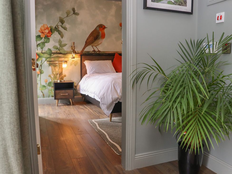 A bedroom with a bed and a nightstand at Robins Rest at The Lodge, Ahanaglogh near Kilmacthomas, County Waterford
