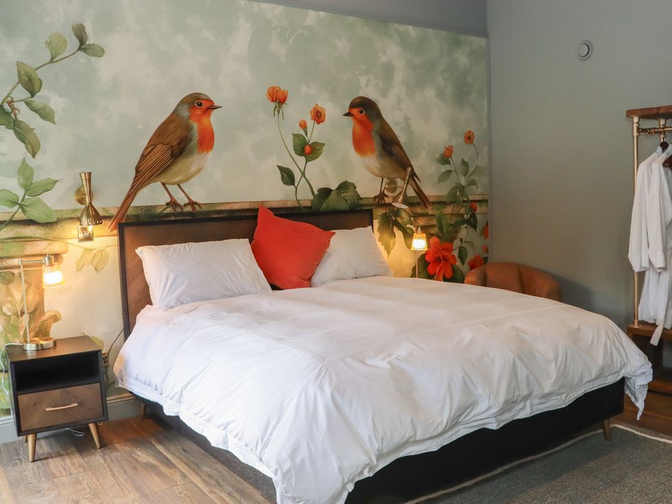 A bedroom with a bed and wall art at Robins Rest at The Lodge Ahanaglogh near Kilmacthomas, County Waterford