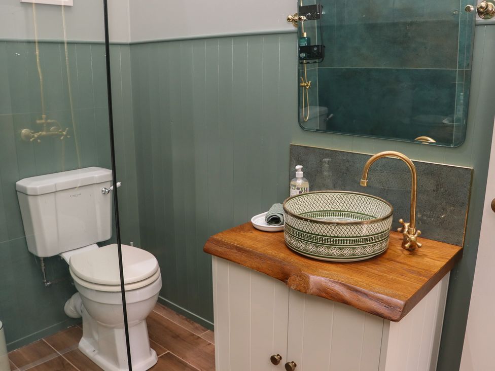 A bathroom with a toilet and a sink at Robins Rest at The Lodge Ahanaglogh near Kilmacthomas, County Waterford