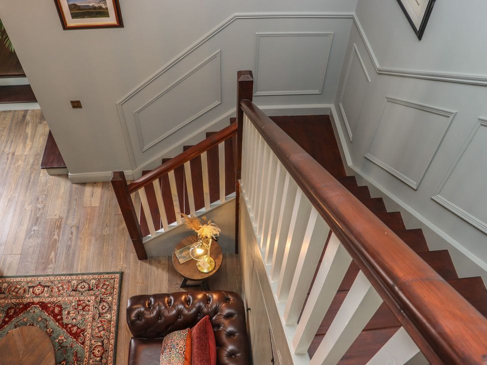An entryway with a staircase and a sofa at Robins Rest at The Lodge Ahanaglogh near Kilmacthomas County Waterford