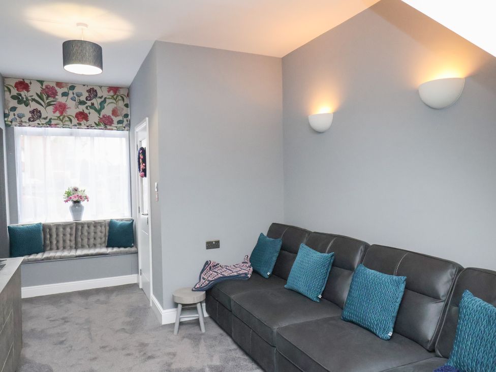 A snug with a grey sofa and cushions at Arthur's House in Middlesbrough