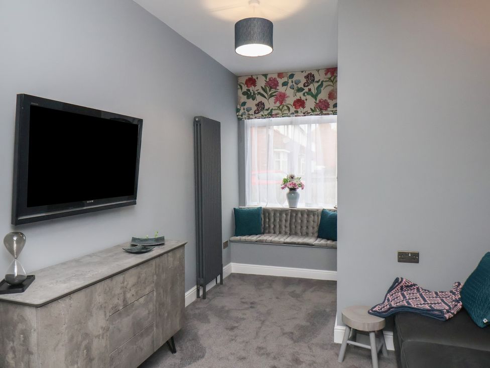 A living room with a tv and window seat at Arthur's House in Middlesbrough