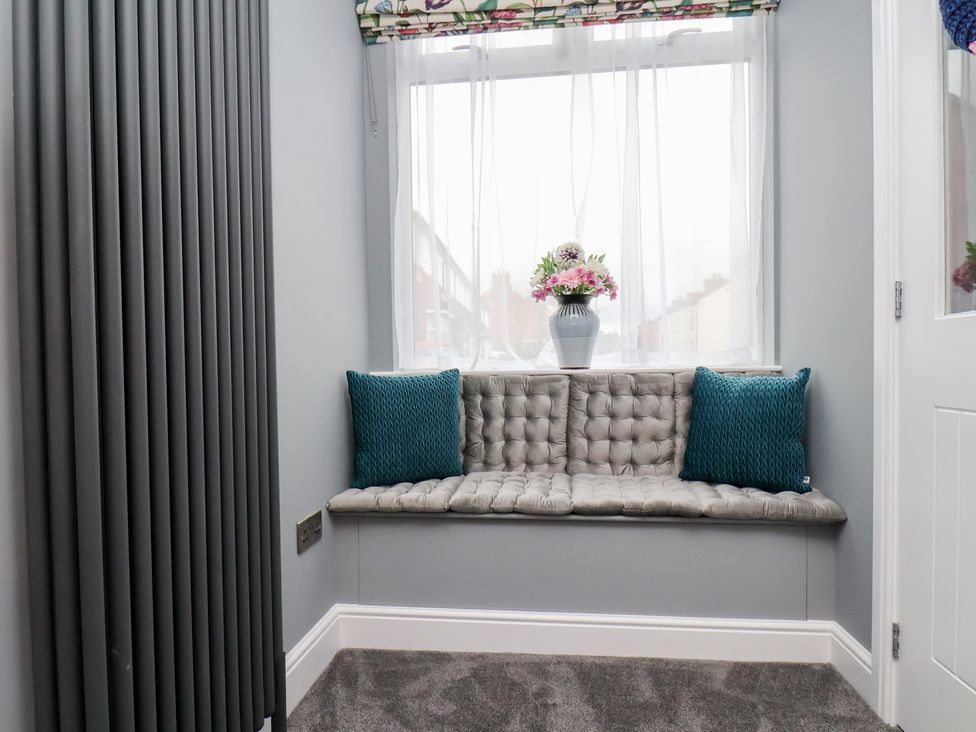 A snug with a seating area and flower vase at Arthur's House in Middlesbrough