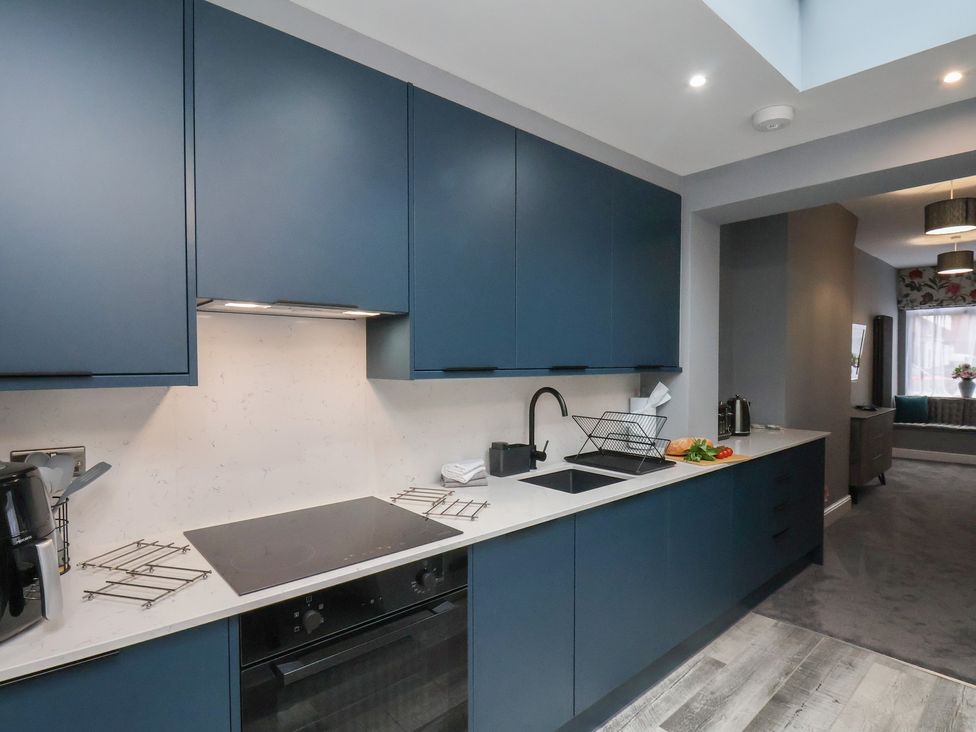 A kitchen with cabinets and appliances at Arthur's House in Middlesbrough