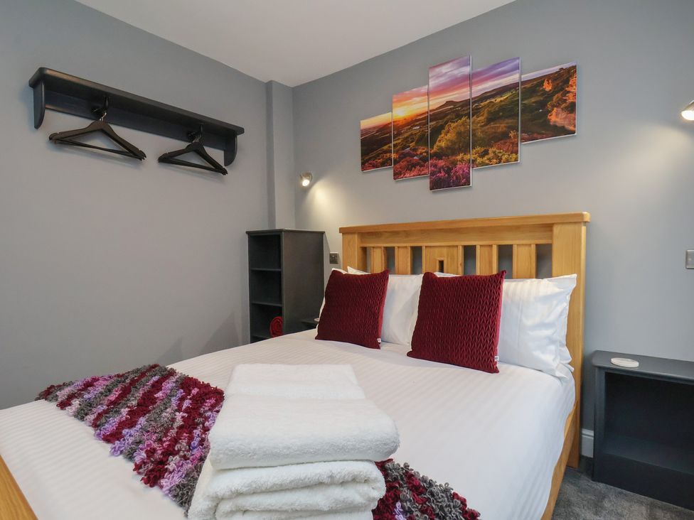 A bedroom with a bed and artwork on the wall at Arthur's House in Middlesbrough