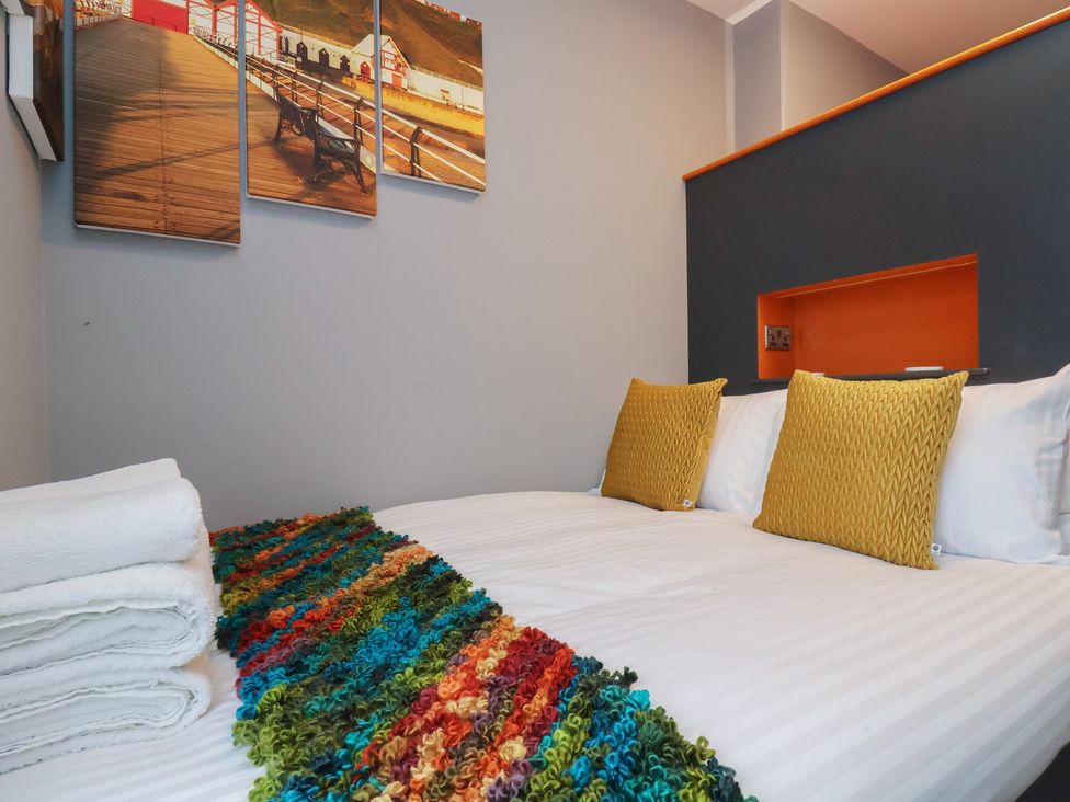 A bedroom with a double bed and colorful decor at Arthur's House in Middlesbrough