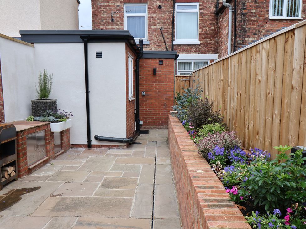 A garden with flowers and a path at Arthur's House in Middlesbrough
