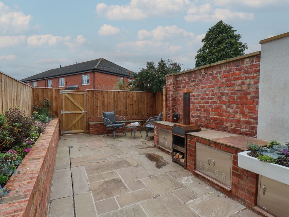 An outdoor space with seating and a fireplace at Arthur's House in Middlesbrough