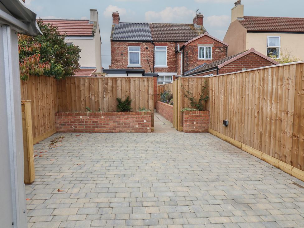 A garden with brick wall and pavement at Arthur's House in Middlesbrough
