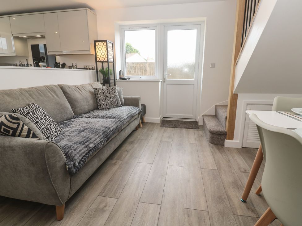 A living room with a sofa and table at Cosy Retreat 