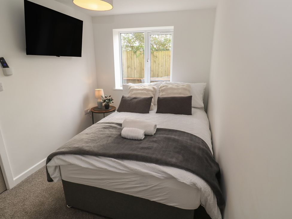 A bedroom with a bed and television at Cosy Retreat in 
