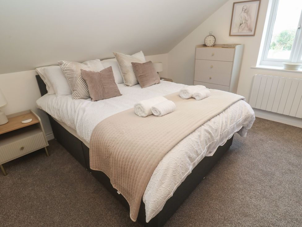 A bedroom with a bed and nightstand at Cosy Retreat in 