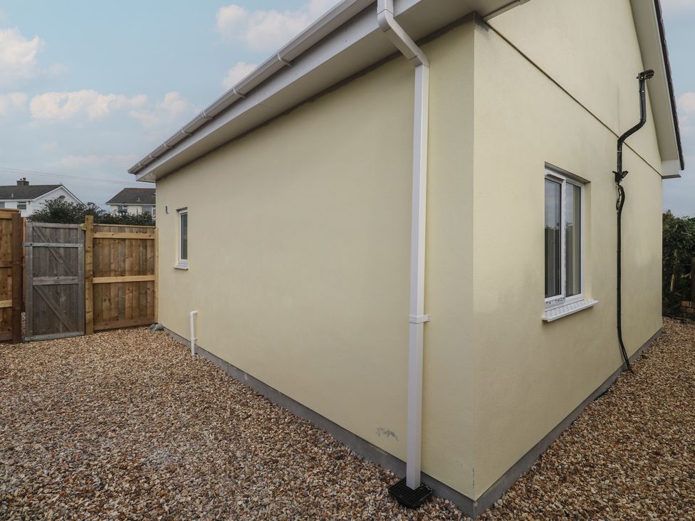 A house exterior with a window and door at Cosy Retreat 