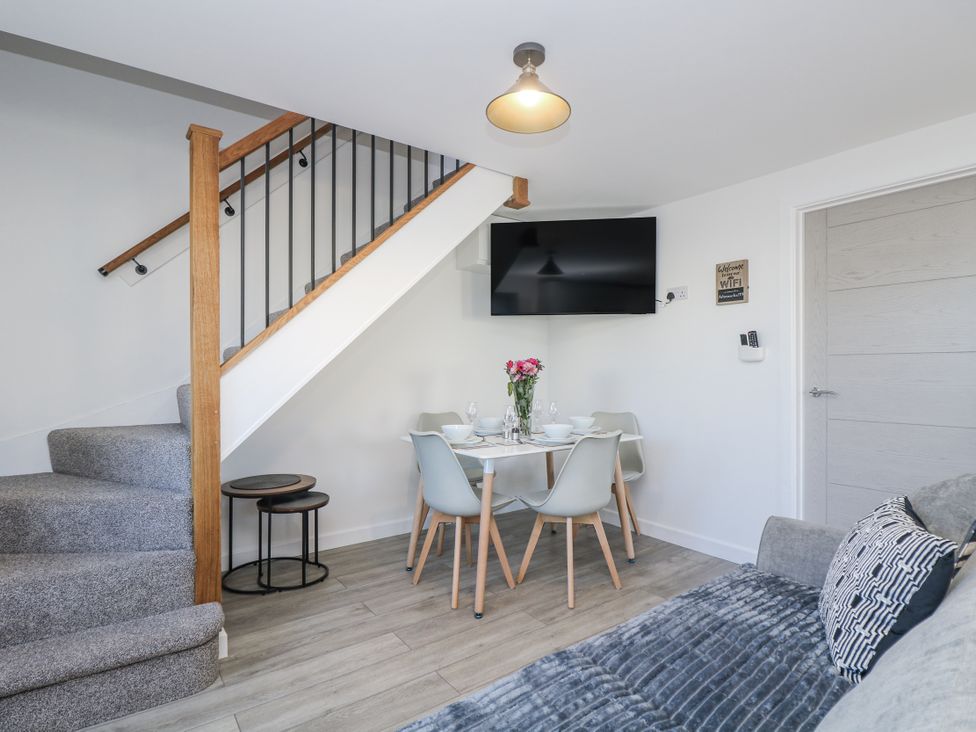 A living room with a dining table and sofa at Cosy Retreat in Pool