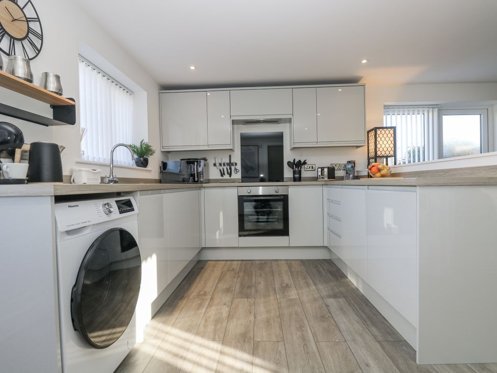 A kitchen with appliances and utensils at Cosy Retreat Pool