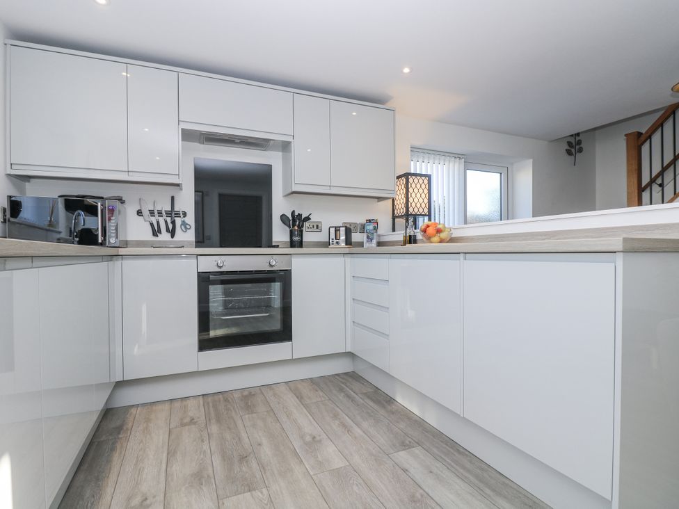 A kitchen with cabinets and appliances at Cosy Retreat in Pool