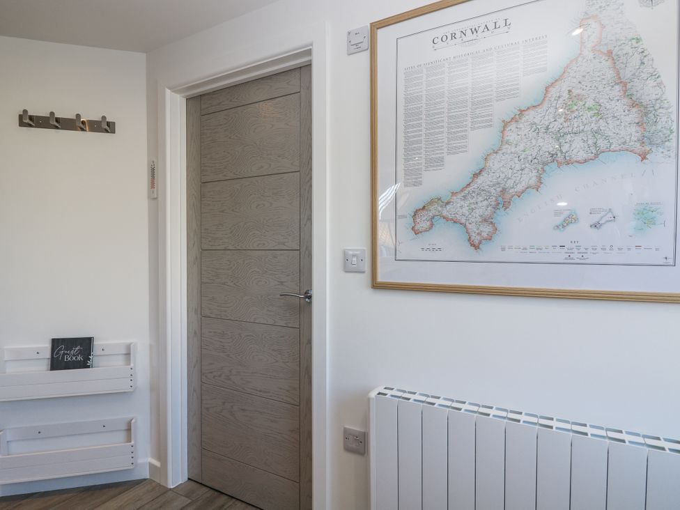 A hallway with a door and a map on the wall at Cosy Retreat in Pool