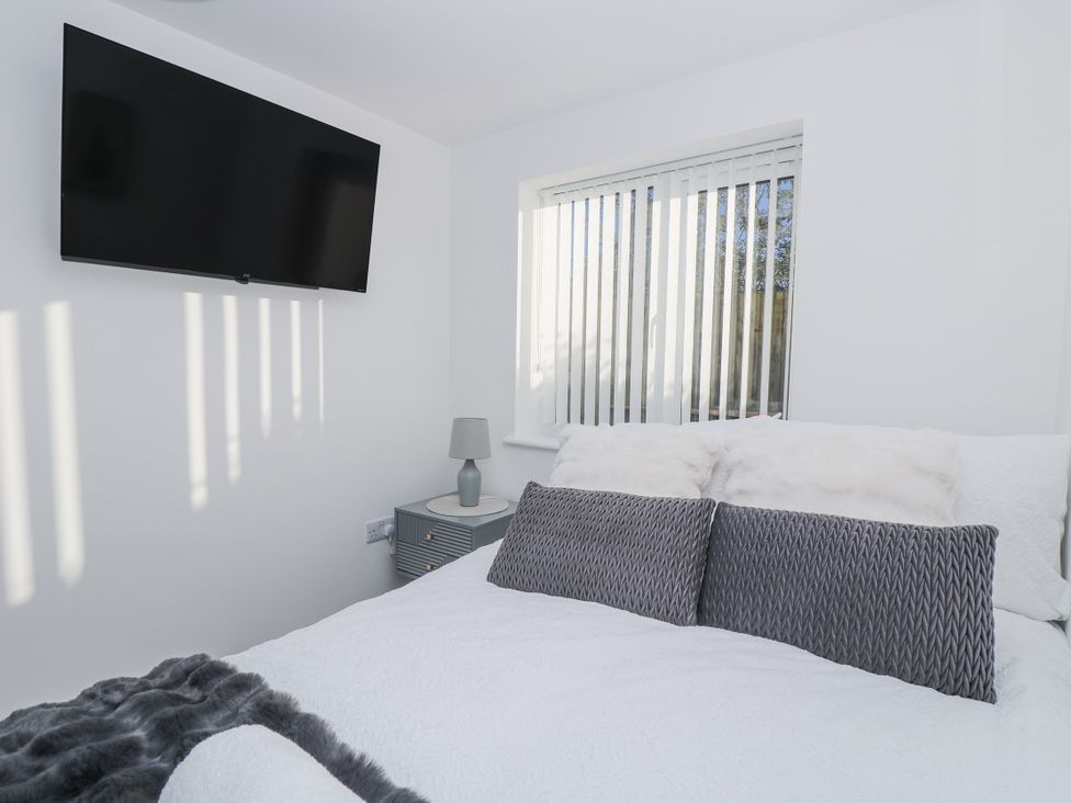 A bedroom with a bed and television at Cosy Retreat in Pool