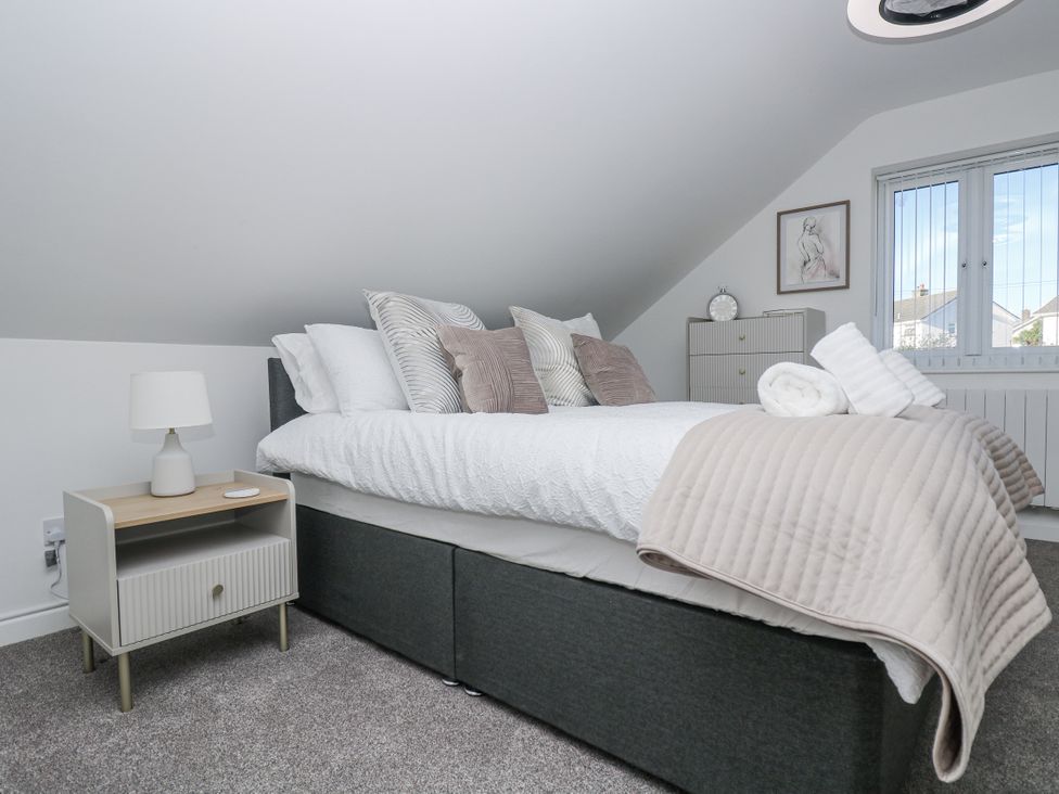 A bedroom with a bed and nightstand at Cosy Retreat in Pool