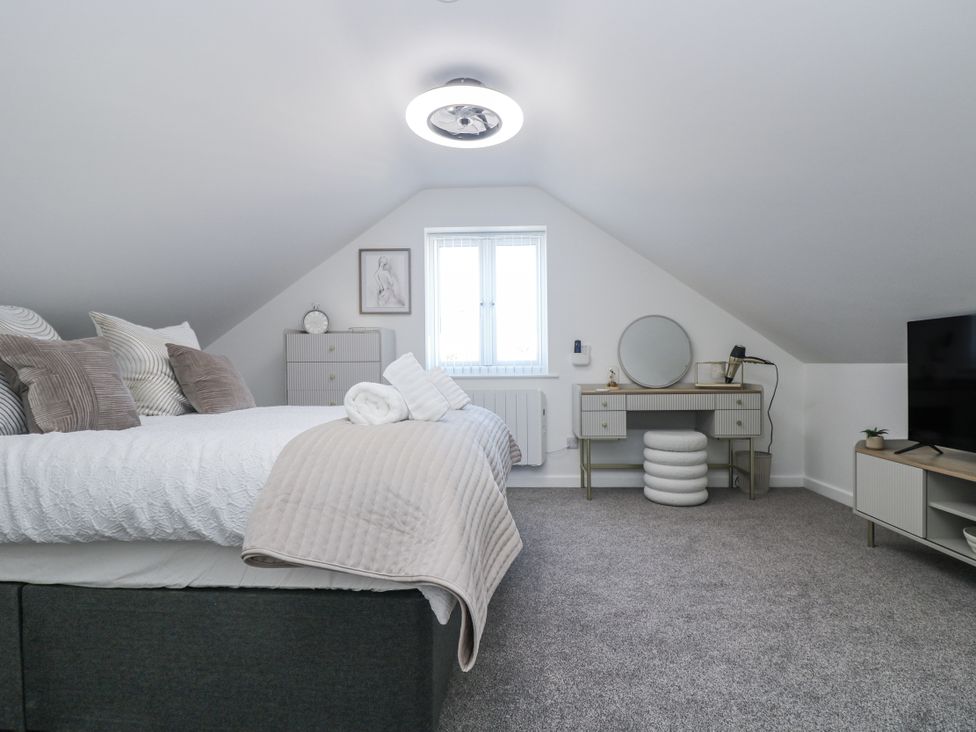 A bedroom with a bed and dresser at Cosy Retreat in Pool