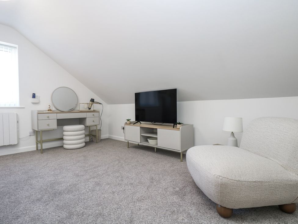 A living room with a tv and storage unit at Cosy Retreat in Pool