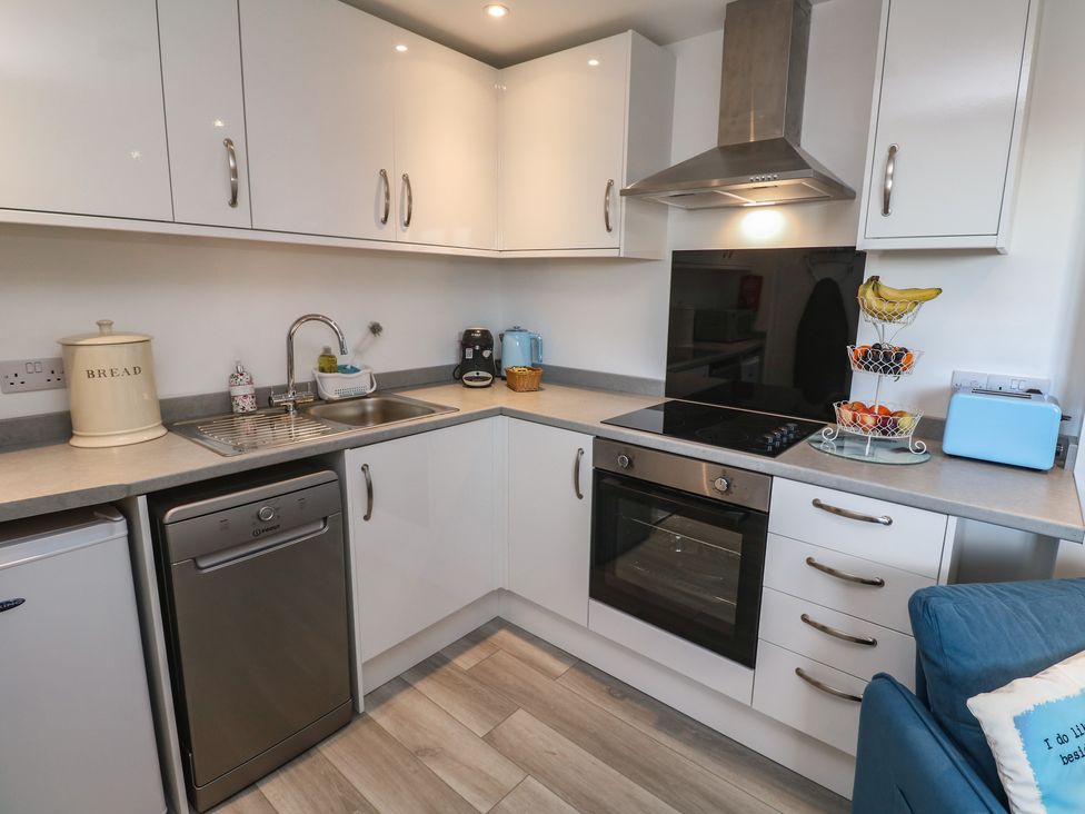 A kitchen with appliances and storage at Sea Whispers in Marazion