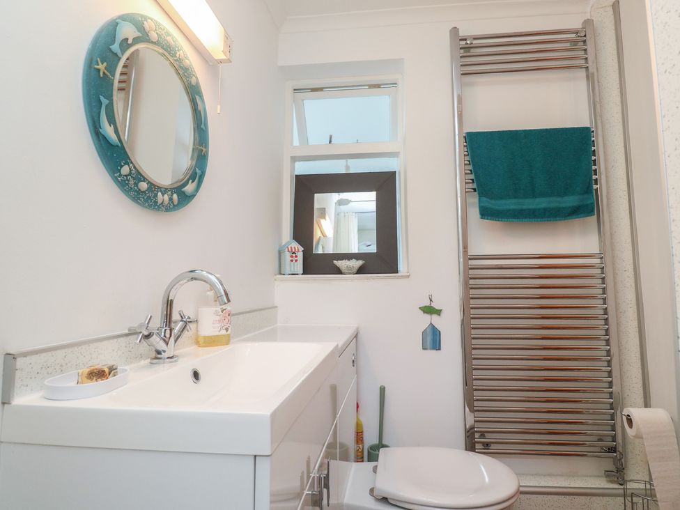 A bathroom with a sink and toilet at Sea Whispers in Marazion
