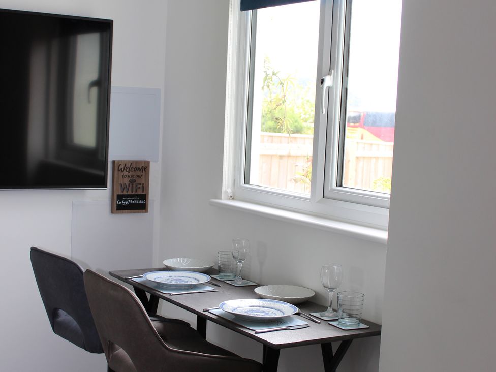 A dining area with a table set for two at Sea Whispers in Marazion
