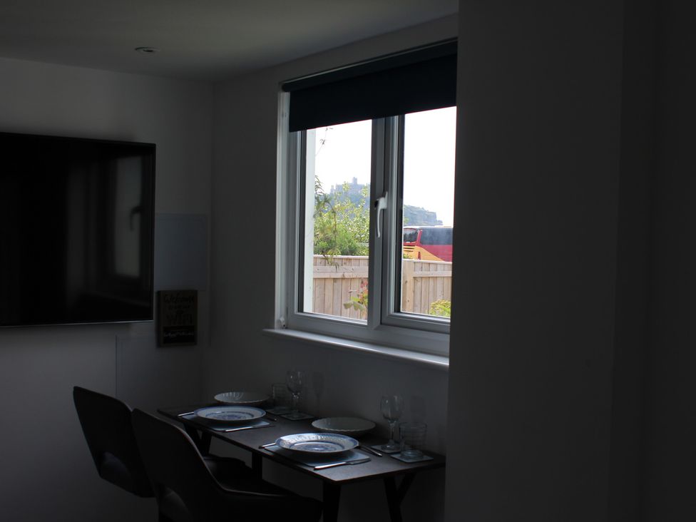 A dining room with a table set for two at Sea Whispers in Marazion