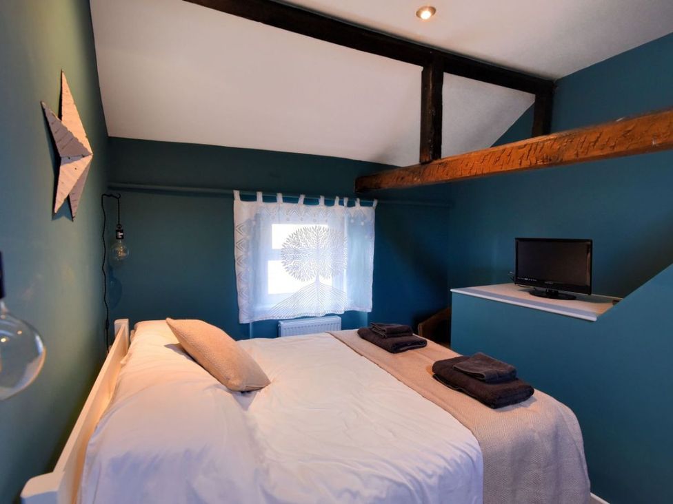 A bedroom with a bed and television at proposed 3 bed apartment Lyme Regis