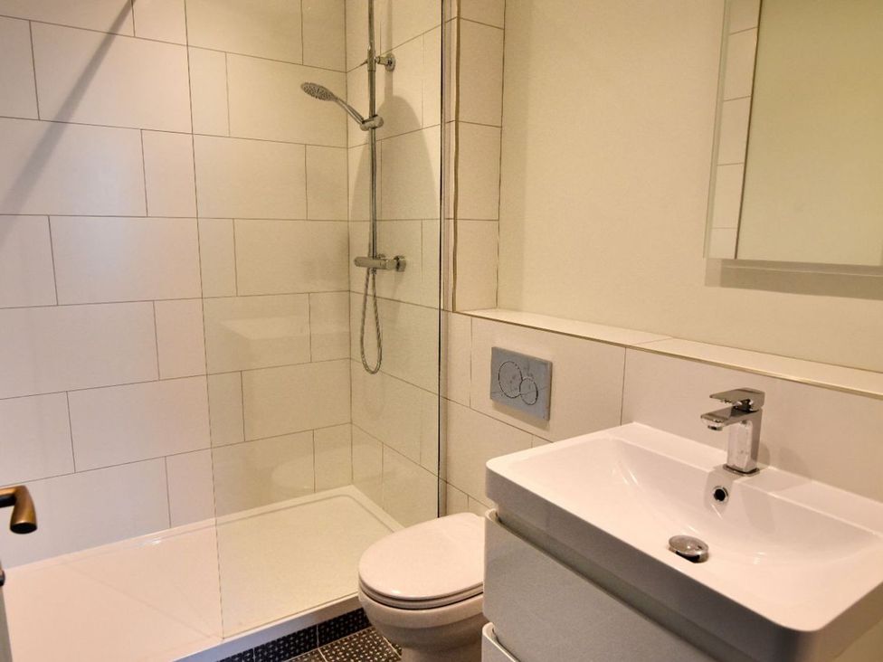 A bathroom with a shower and sink at proposed 3 bed apartment Lyme Regis
