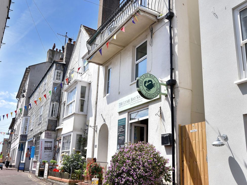 A building with a sign and flowers outside at proposed 3 bed apartment in Lyme Regis