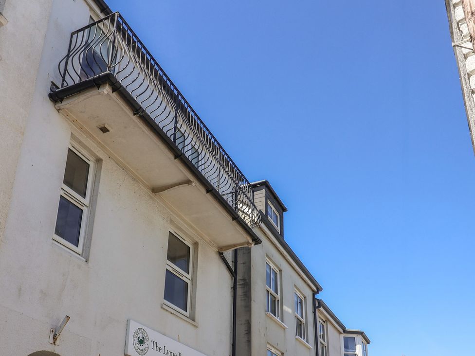 A building with a balcony and windows at Avocet Lyme Regis