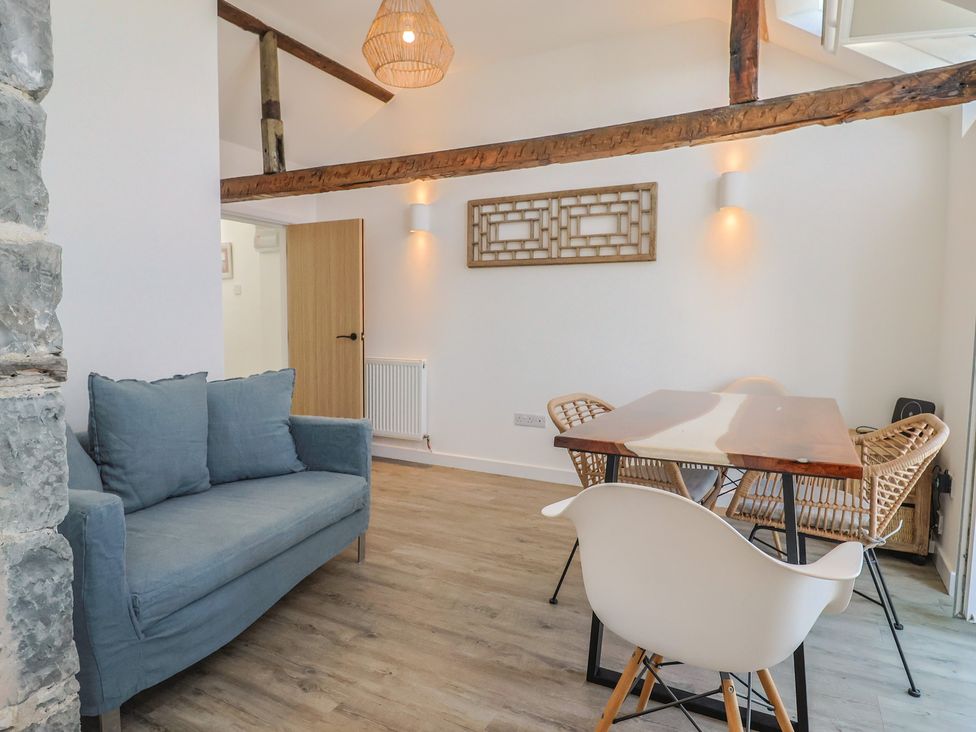 A living room with a couch and dining table at Avocet in Lyme Regis