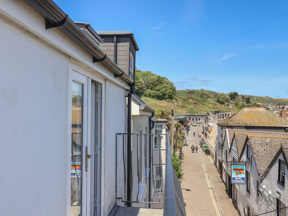 A view of a street with buildings and people at Avocet in Lyme Regis