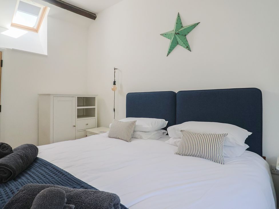 A bedroom with a bed and bedside table at Avocet in Lyme Regis