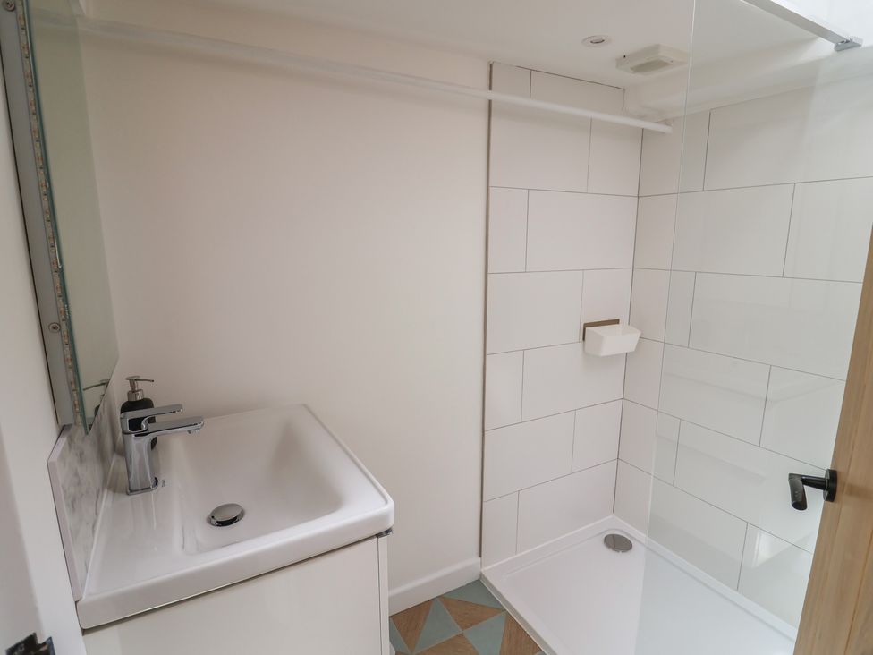 A bathroom with a sink and shower at Avocet in Lyme Regis
