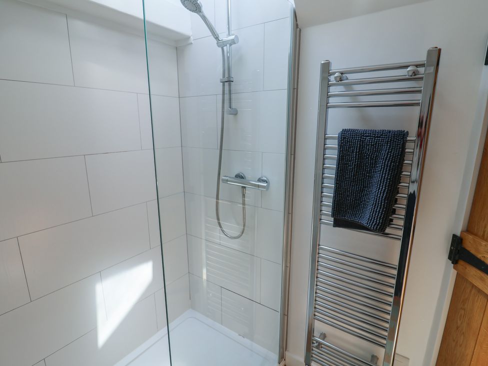 A shower with a towel rail and towel at Avocet in Lyme Regis